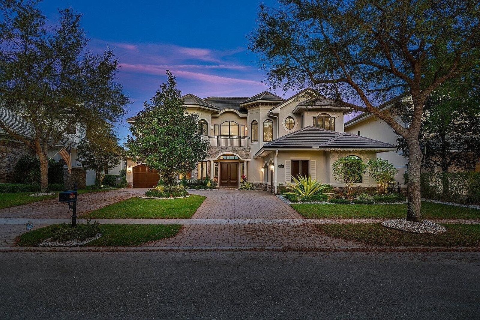 Florida home glowing at dusk with vibrant sky