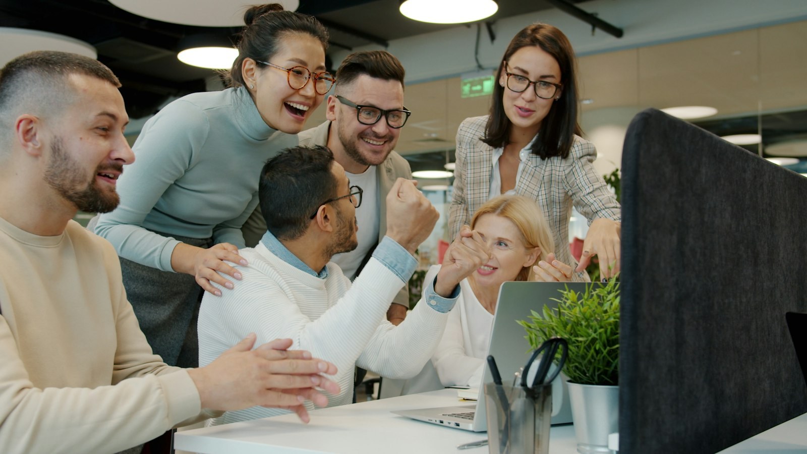 The City Capital Real Estate team celebrating together in the office