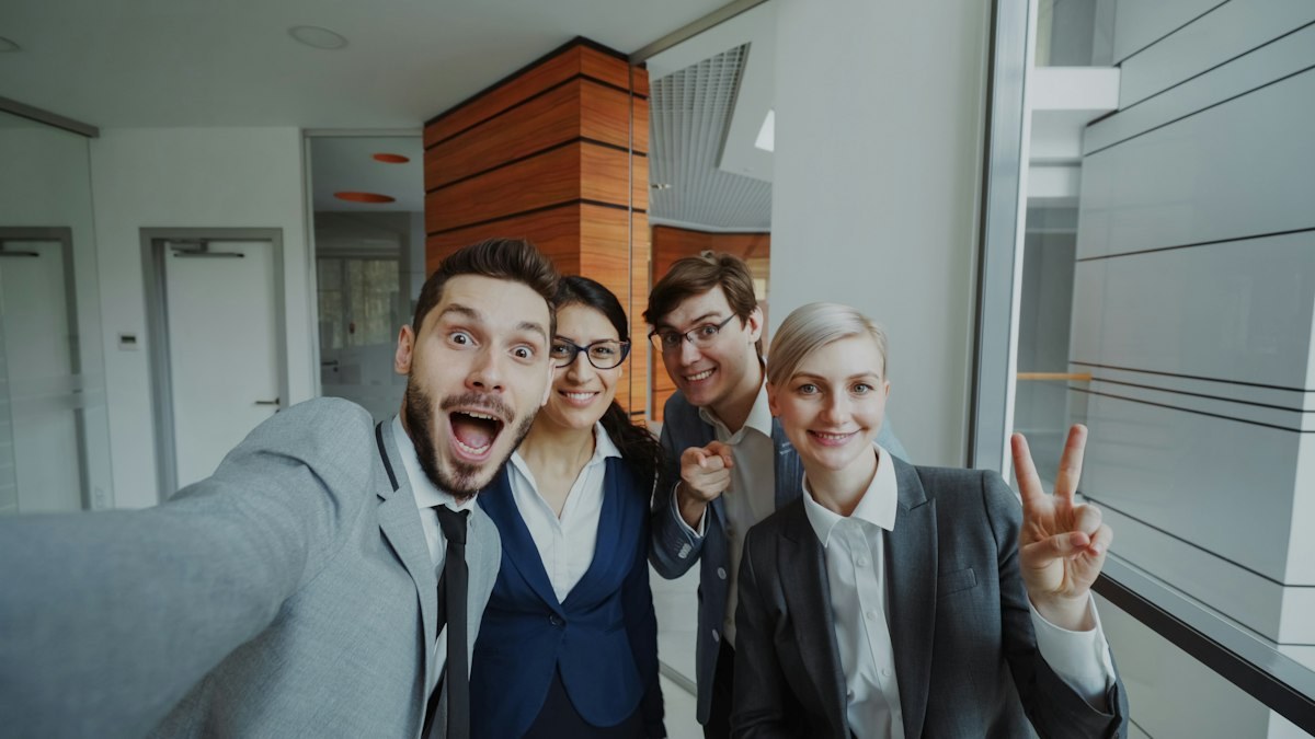 The team taking a group photo in the office